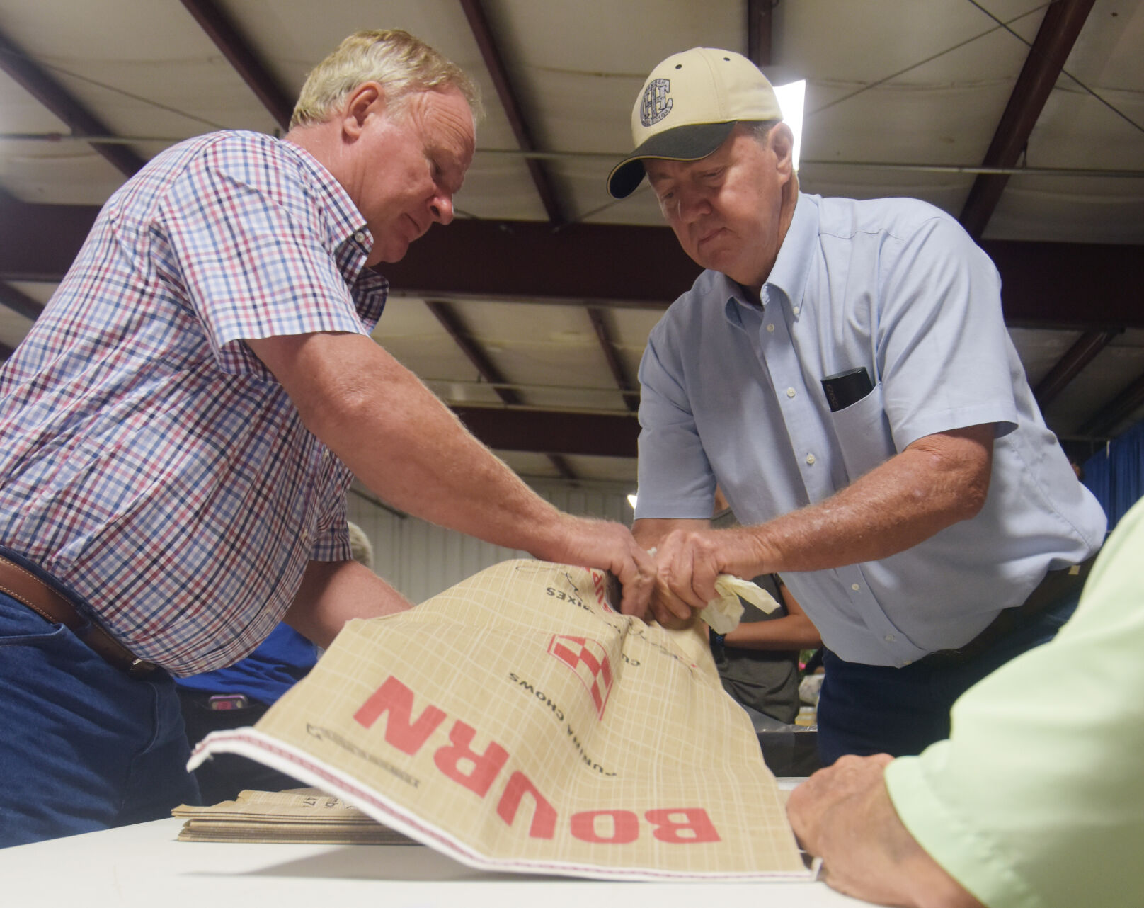 Paul Little and Stan Lynn bag up an auctioned-off ham
